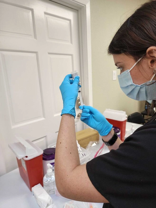 student drawing liquid from vial student drawing liquid from vial